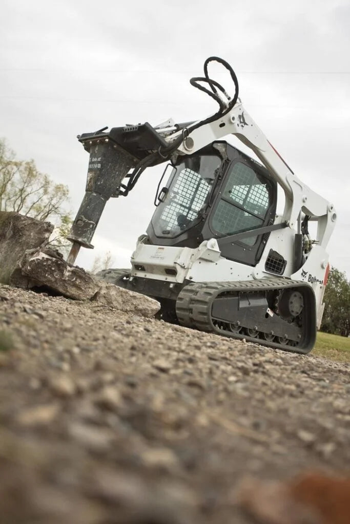 Bobcat equipment with hydraulic breaker attachment outside
