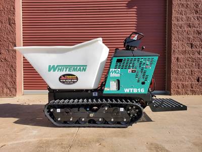 side view of a whiteman cement buggy in front of garage door