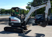 side view of a Bobcat excavator in a parking lot