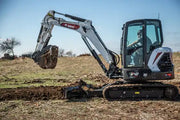 bobcat backfilling a trench with dirt