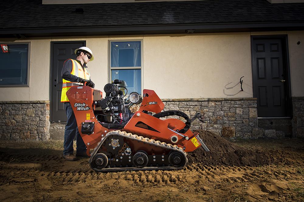 side view of ditch witch trencher being used