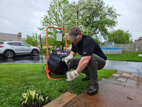 man using easy rooter outside in ground