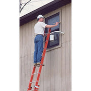 man standing on a ladder to paint the side of a house