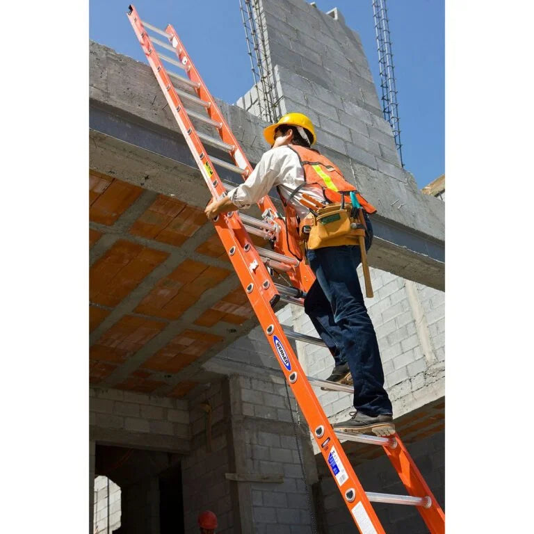 man climbing an extension ladder