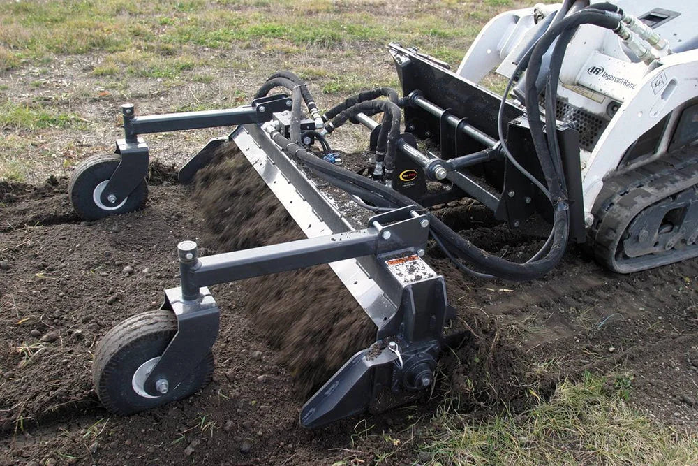 skid loader with ground rake attachment