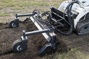 skid loader with ground rake attachment