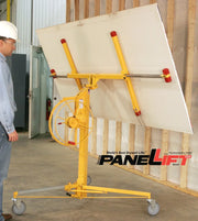 man looking at panellift holding a sheet of drywall near a wall