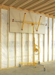 panellift holding a sheet of drywall high in the air next to a studded wall