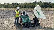 man standing next to cement buggy in field