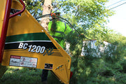 close up of tree branches going into wood chipper